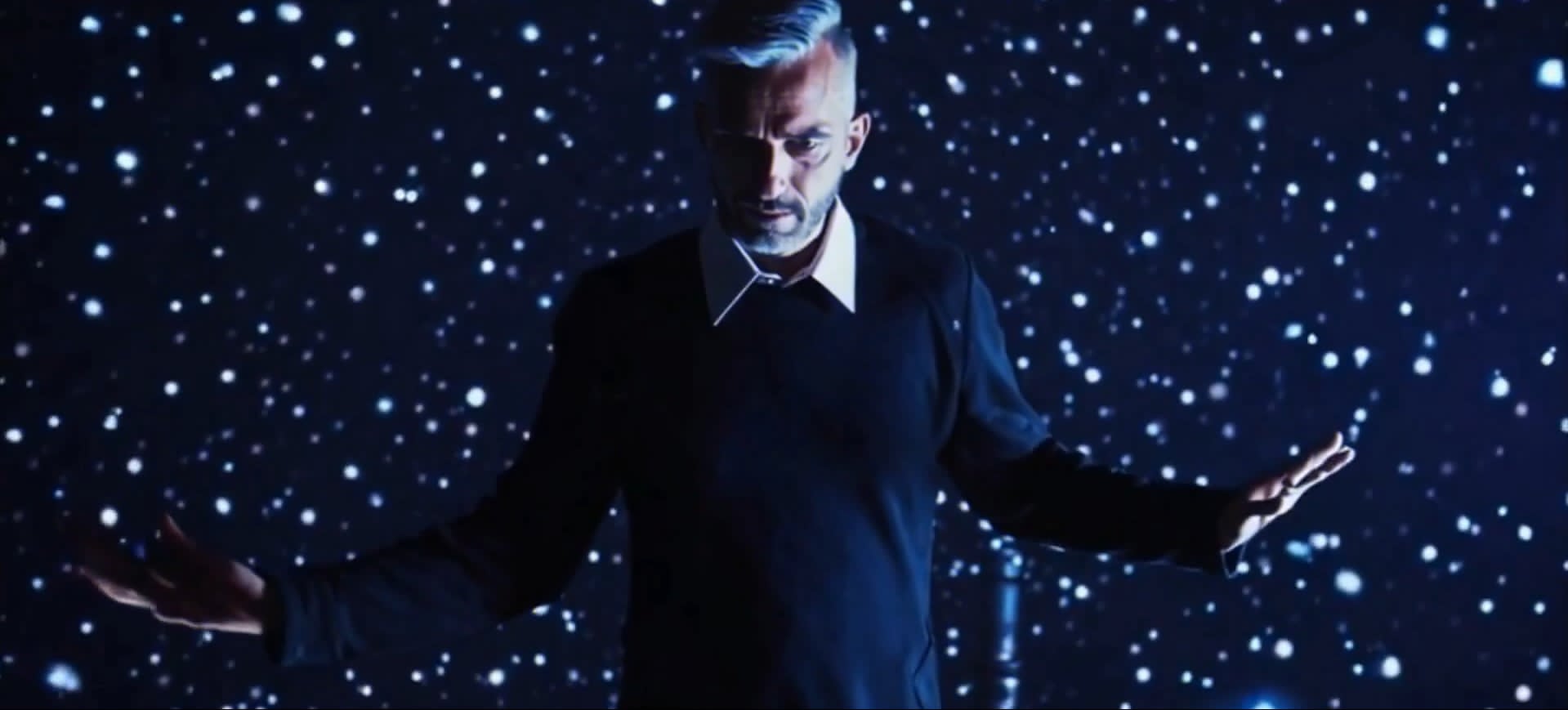 EgoB performing in a star-lit stage environment